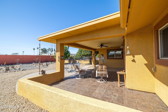 view of patio / terrace with a fenced backyard and ceiling fan