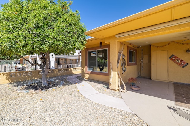 exterior space featuring fence and stucco siding