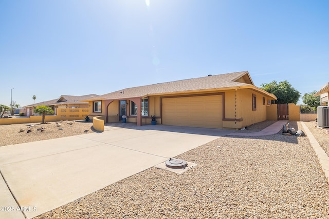 single story home featuring a garage, driveway, a gate, fence, and stucco siding