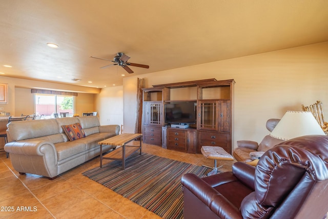 living area with light tile patterned floors, a ceiling fan, and recessed lighting