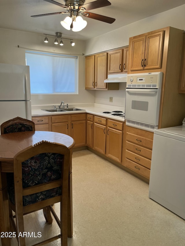 kitchen with ceiling fan, sink, washer / clothes dryer, and white appliances