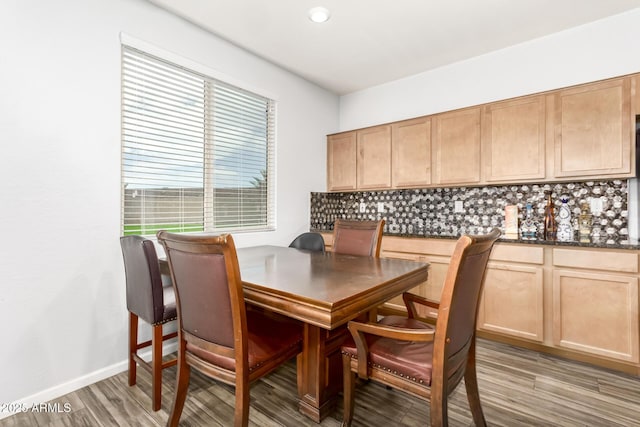 dining room with light wood-style floors and baseboards