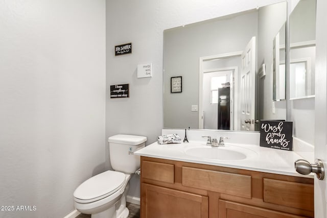 half bath with vanity and toilet