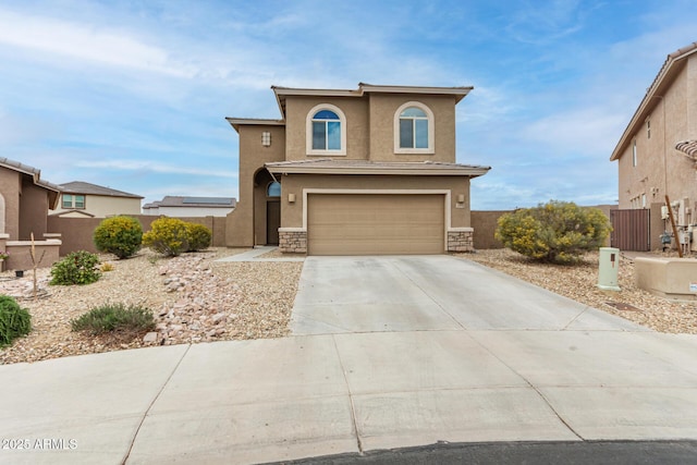 view of front facade featuring stone siding, stucco siding, a garage, and fence