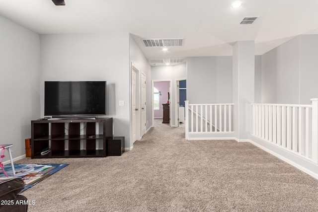 interior space with carpet, visible vents, and baseboards