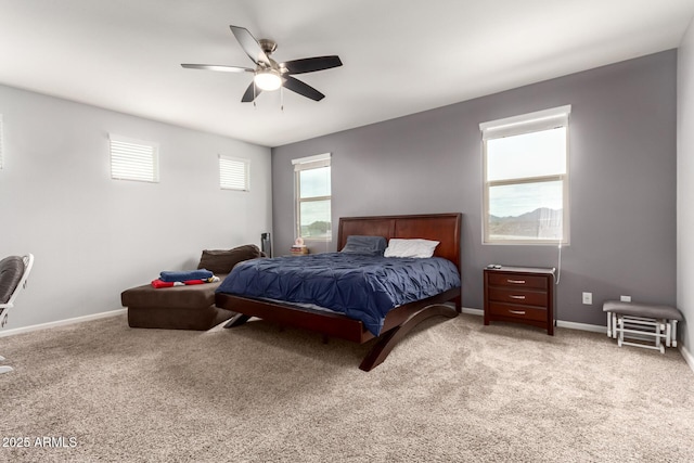 bedroom with a ceiling fan, baseboards, and carpet floors