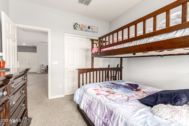 carpeted bedroom featuring visible vents, baseboards, and a closet