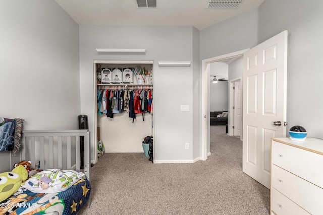 bedroom with a closet, visible vents, and carpet