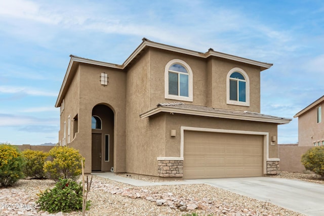 view of front of house featuring an attached garage, stone siding, driveway, and stucco siding