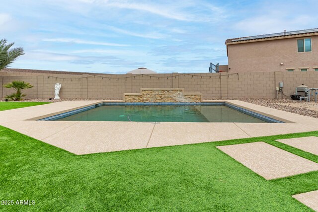 view of swimming pool with a yard, a fenced backyard, and a fenced in pool