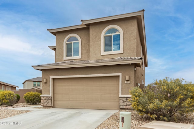 view of front of house with stucco siding, stone siding, concrete driveway, and an attached garage