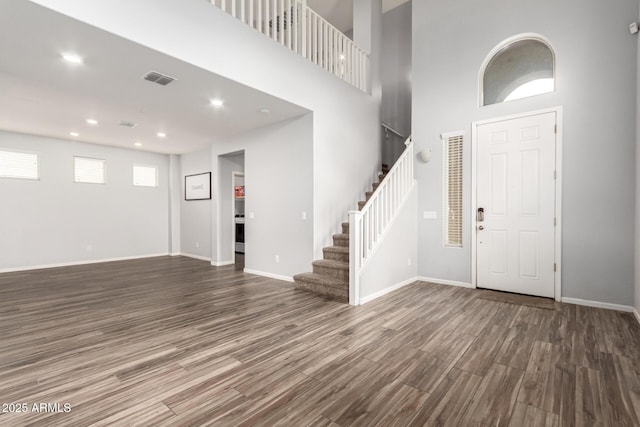 foyer featuring visible vents, baseboards, stairway, recessed lighting, and wood finished floors