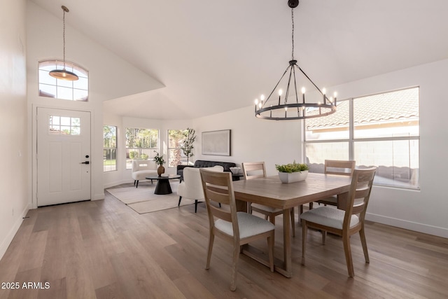 1627 W Maplewood St, Chandler, AZ 85286 - dining room with a chandelier, baseboards, light wood-style floors, and high vaulted ceiling