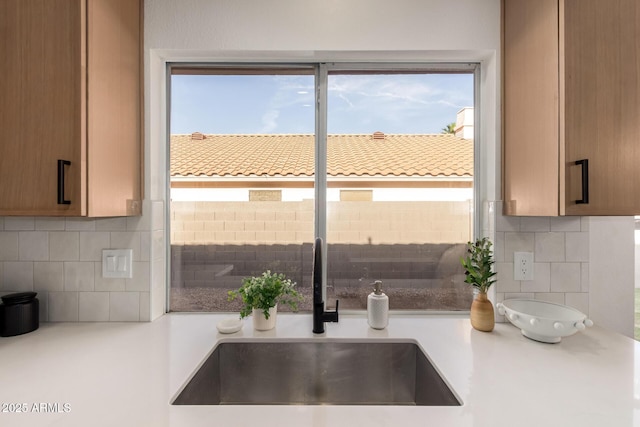 1627 W Maplewood St, Chandler, AZ 85286 - kitchen featuring a sink, decorative backsplash, and light countertops