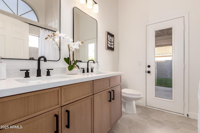 1627 W Maplewood St, Chandler, AZ 85286 - full bath with toilet, double vanity, healthy amount of natural light, and tile patterned floors