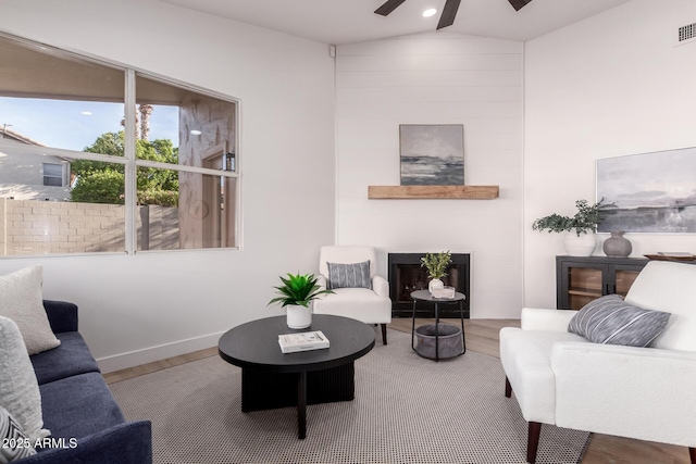1627 W Maplewood St, Chandler, AZ 85286 - living room with wood finished floors, ceiling fan, vaulted ceiling, a fireplace, and baseboards