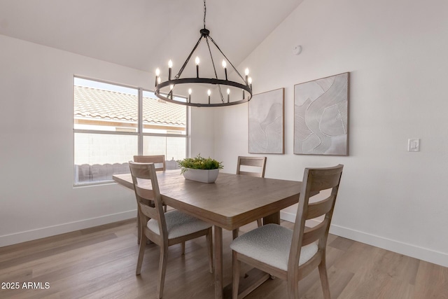 1627 W Maplewood St, Chandler, AZ 85286 - dining room with vaulted ceiling, a chandelier, light wood finished floors, and baseboards