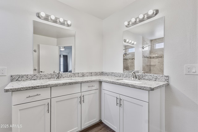 4632 E Kachina Trl, Phoenix, AZ 85044 - full bath featuring tiled shower, double vanity, wood finished floors, and ceiling fan