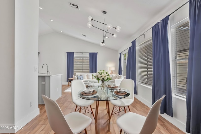 4632 E Kachina Trl, Phoenix, AZ 85044 - dining space featuring vaulted ceiling, light wood-style flooring, baseboards, and a chandelier