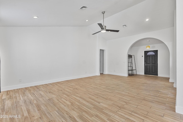 4632 E Kachina Trl, Phoenix, AZ 85044 - empty room with arched walkways, a ceiling fan, light wood-style floors, baseboards, and high vaulted ceiling