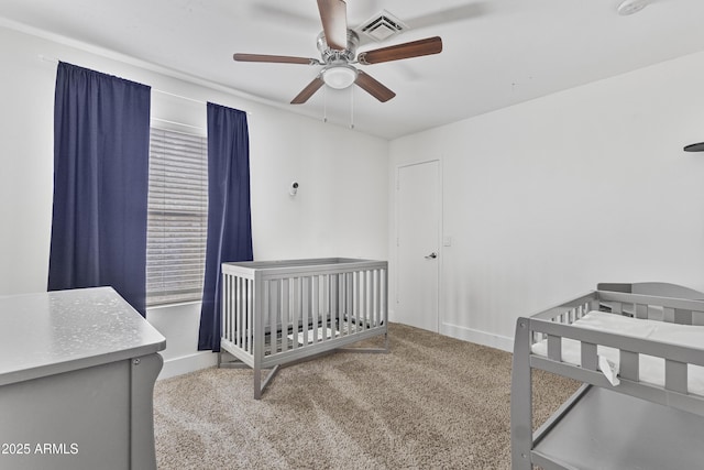 4632 E Kachina Trl, Phoenix, AZ 85044 - carpeted bedroom with baseboards, a crib, and a ceiling fan