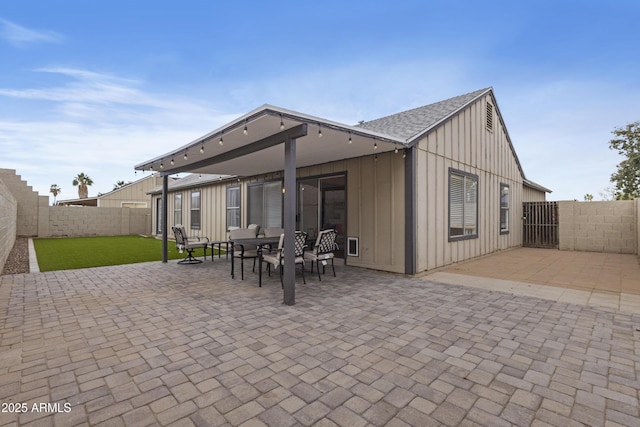 4632 E Kachina Trl, Phoenix, AZ 85044 - back of house featuring board and batten siding, a patio area, a fenced backyard, and a shingled roof