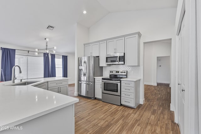 4632 E Kachina Trl, Phoenix, AZ 85044 - kitchen featuring stainless steel appliances, a sink, light countertops, backsplash, and a chandelier