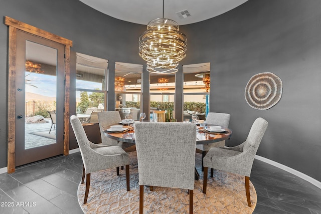 dining room with a notable chandelier, marble finish floor, visible vents, and baseboards