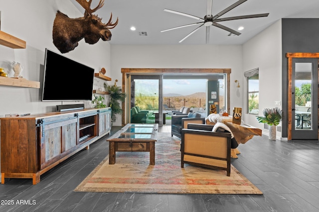 living room featuring baseboards, a ceiling fan, wood finished floors, and recessed lighting