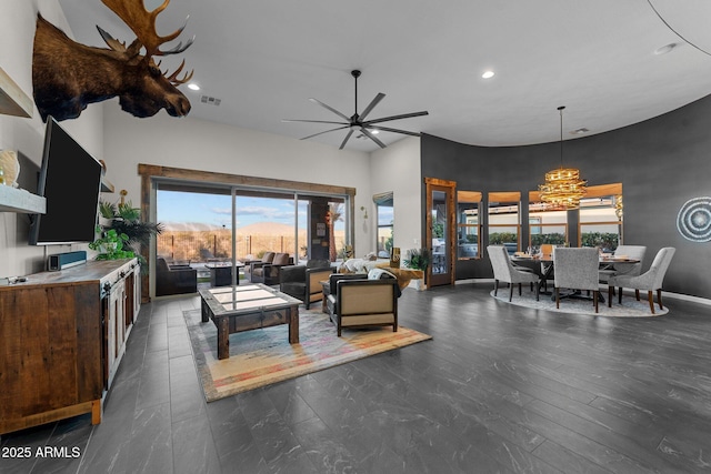 living room featuring recessed lighting, visible vents, a towering ceiling, ceiling fan, and baseboards