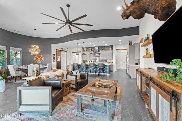 living area featuring recessed lighting, visible vents, and ceiling fan with notable chandelier