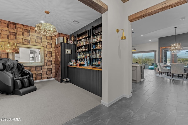 bar with a chandelier, a bar, visible vents, and baseboards