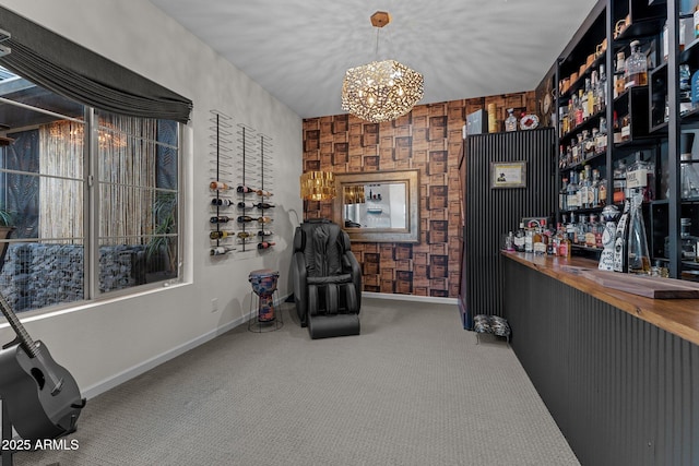 living area with carpet floors, baseboards, a dry bar, and a chandelier