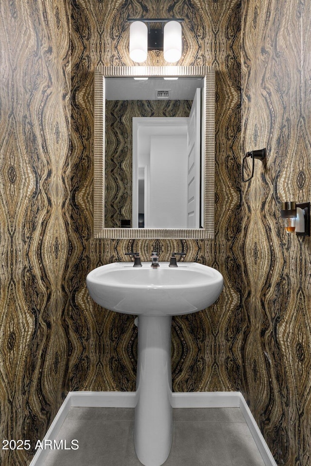 bathroom with tile patterned floors and wallpapered walls