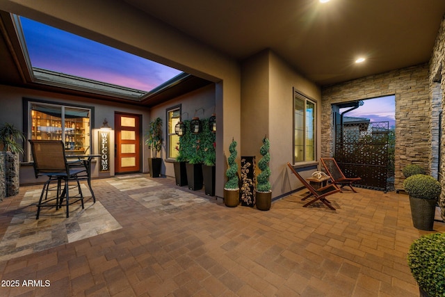 view of patio terrace at dusk