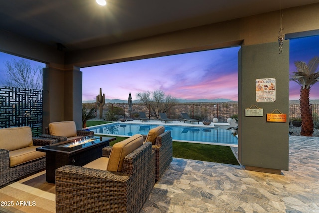 view of patio / terrace featuring an outdoor fire pit, fence, and a fenced in pool