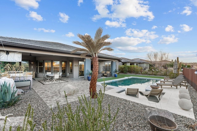 view of pool with a fenced in pool, a patio, an outdoor hangout area, ceiling fan, and fence