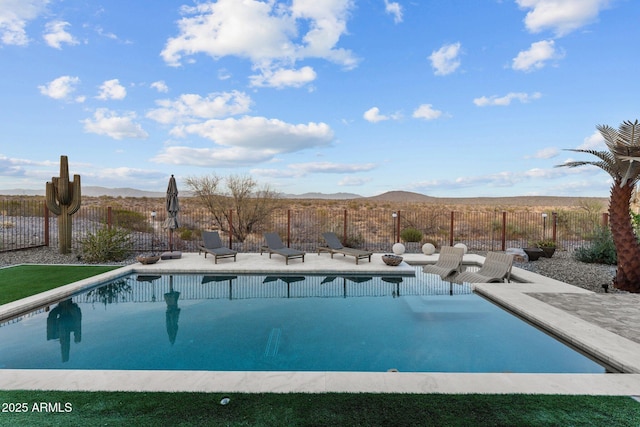 view of pool with fence, a mountain view, a fenced in pool, and a patio