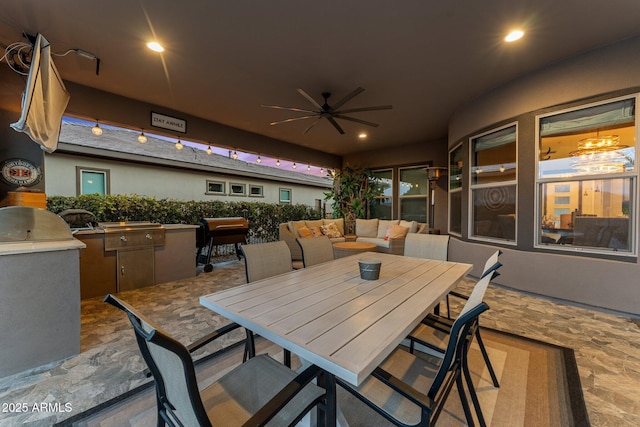 view of patio / terrace featuring outdoor dining area, area for grilling, an outdoor kitchen, a ceiling fan, and an outdoor hangout area