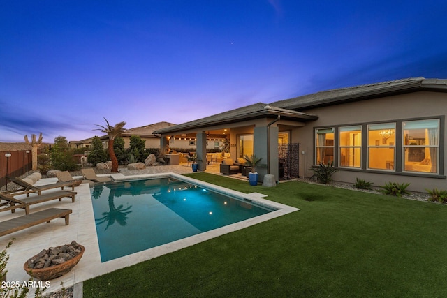 pool with a yard, a patio, and fence