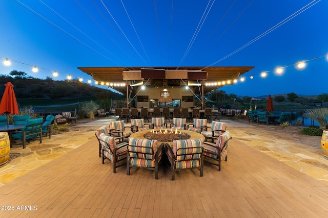 3254 Buckaroo Ct, Wickenburg, AZ 85390 - patio at night featuring an outdoor fire pit