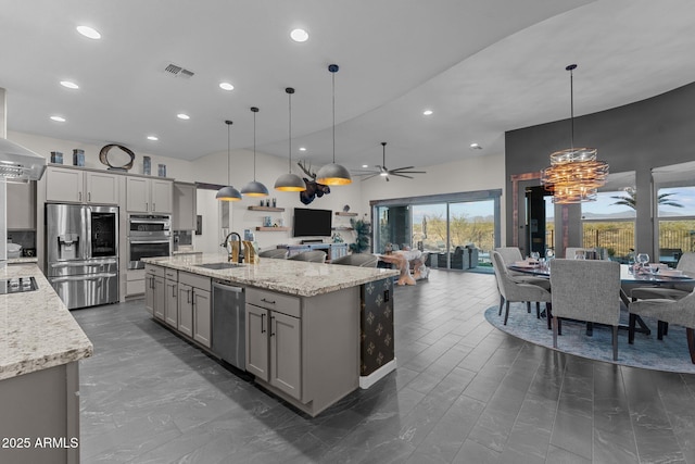 kitchen with stainless steel appliances, a sink, visible vents, open floor plan, and gray cabinets