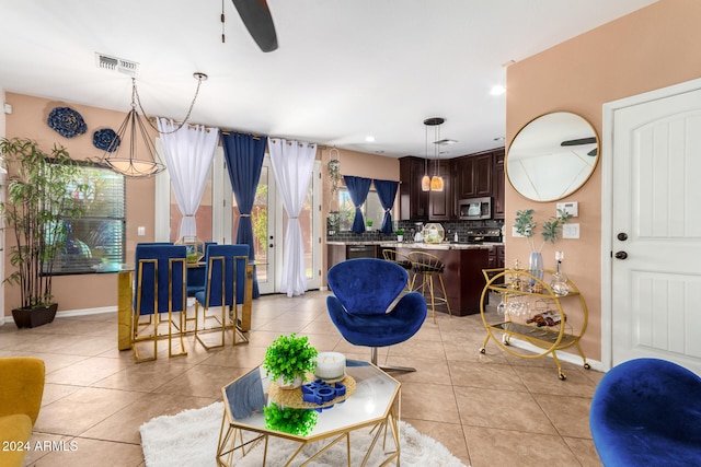 living room featuring ceiling fan and light tile patterned flooring