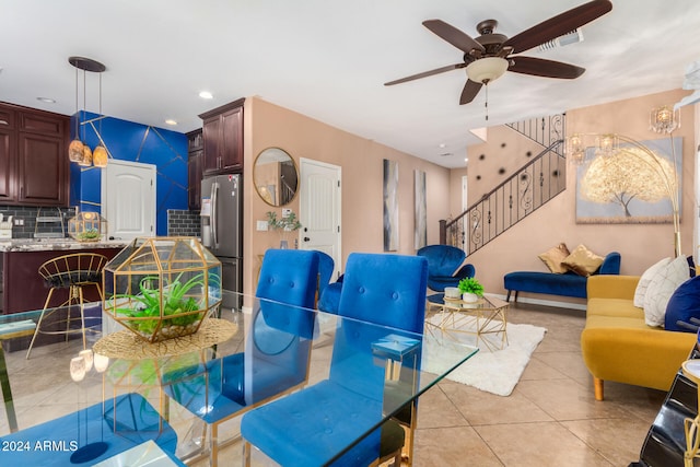 dining space featuring ceiling fan and light tile patterned floors