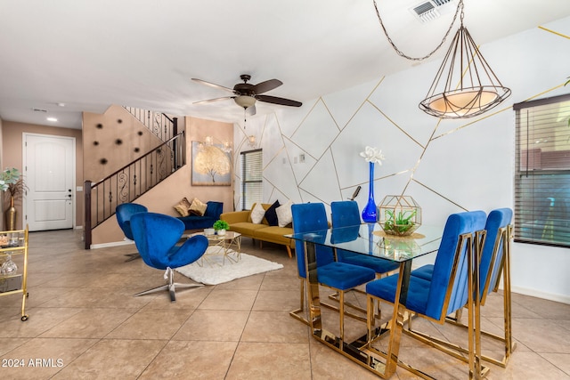 dining space with tile patterned flooring and ceiling fan