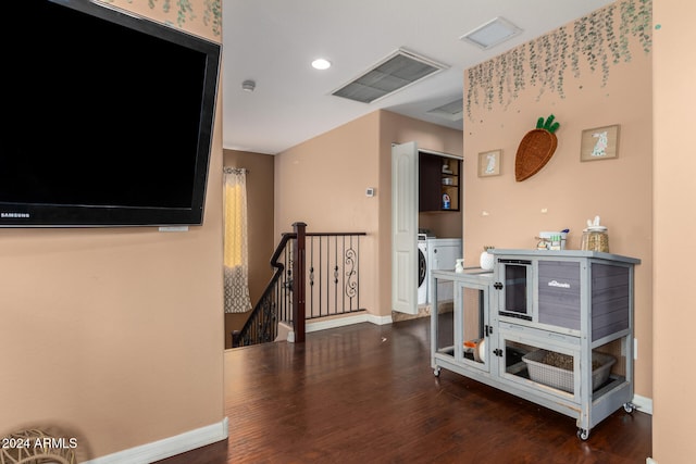 interior space with washing machine and dryer and dark hardwood / wood-style floors