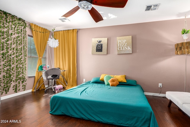 bedroom with ceiling fan and dark hardwood / wood-style floors