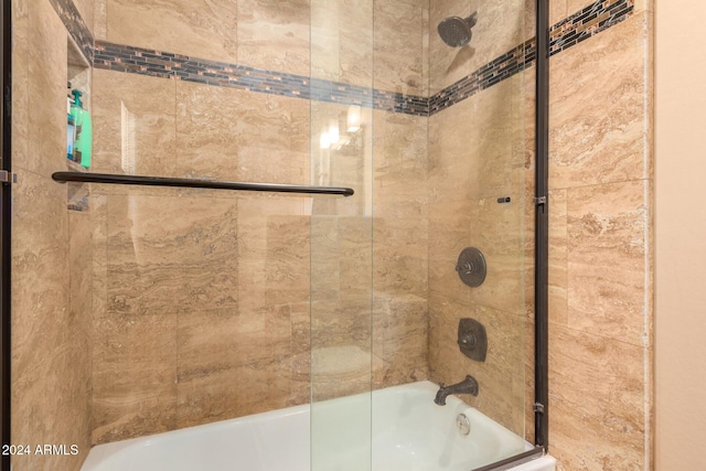 bathroom featuring shower / bath combination with glass door