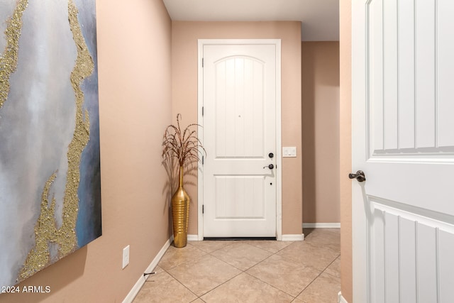 entryway with light tile patterned floors