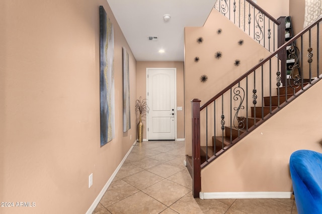 stairs with tile patterned flooring